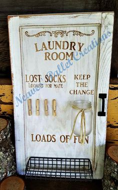 the laundry room door sign is made out of wood and has several hooks on it