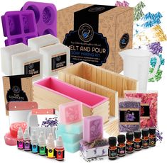 an assortment of essential oils and soaps are displayed in front of a box with the contents