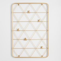 a white and gold geometric wall hanging