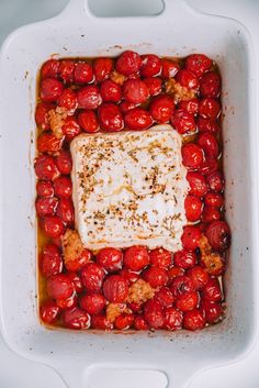 tomatoes and meat in a white casserole dish