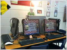 two computer monitors sitting on top of a desk next to a keyboard and monitor screen