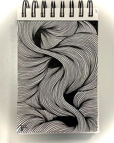 a spiral notebook with black and white lines on it