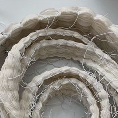 three pieces of white fabric are stacked on top of each other with wires attached to them