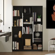 a living room with bookshelves and a painting on the wall