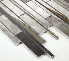 several different types of metal bars on a white surface