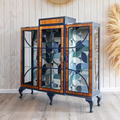 an art deco display cabinet with glass doors