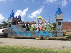 a group of people riding on the back of a float