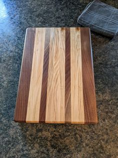 a wooden cutting board sitting on top of a counter