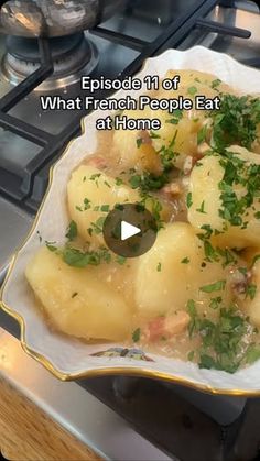 a white plate topped with potatoes and garnish on top of a kitchen stove