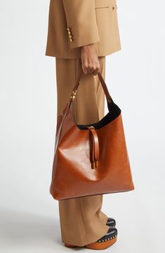 This slouchy calfskin-leather hobo bag blends a modern aesthetic with a '70s folk spirit, and of course has the Marcie line's signature slip-tassel closure. Bridge-tassel closure Shoulder strap Interior zip wall pocket Protective metal feet Leather Made in Italy Designer Handbags This brand has B Corp certification, representing business practices with emphasis on social and environmental performance, accountability and transparency This brand meets Nordstrom Responsible Brands criteria: brand a Chic Leather-lined Hobo Bag For Work, Leather Hobo Bag With Leather Lining For Work, Chic Textured Calf Leather Hobo Bag, Fall Leather Hobo Bag, Modern Hobo Bag With Leather Lining For Work, Modern Leather Lined Hobo Bag For Work, Workwear Soft Calf Leather Hobo Bag, Calf Leather Top Handle Hobo Bag For Workwear, Brown Calf Leather Bucket Bag For Work