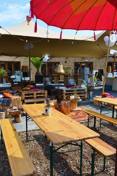 an outdoor seating area with tables and umbrellas