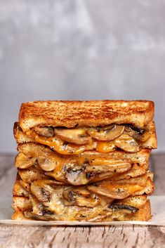 a grilled cheese and mushroom sandwich stacked on top of each other