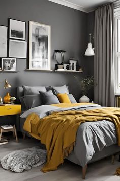 a bedroom with grey walls, yellow accents and pictures on the wall above the bed