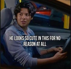 a man sitting in a car with the caption he looks so cute in this for no reason at all