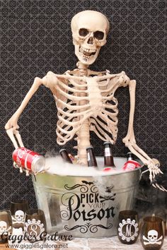 a skeleton sitting in a tub filled with bottles