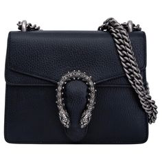 This Gucci shoulder bag is made of black leather and features the dionysus tigger head detail at front, silver-tone hardware, chain-link shoulder straps, canvas lining and snap closure at front. Color: Black Material: Calfskin leather Style #: 421970 Measures: Height 6” x Length 7.5” x Depth 1.5” Drop: 22.5” (One Strap) & 12.5” (Both Straps) Est. Retail: $3300 Comes With: Dust Bag & Box Condition: Good. Stains, marks & discoloration to interior cloth. Smudges to exterior. Made in Italy Gucci Mini, Vanity Bag, Gucci Shoulder Bag, Garment Bags, Black Crystals, Handbag Backpack, Fashion Handbags, Leather Fashion, Chain Strap