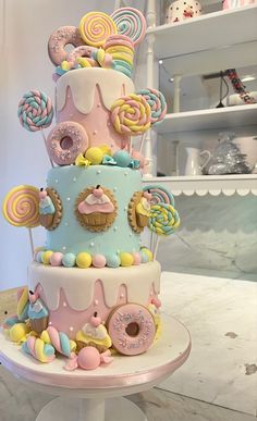 a multi layer cake decorated with candy and lollipops