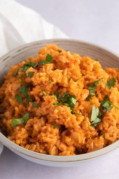 a bowl filled with rice and garnished with cilantro