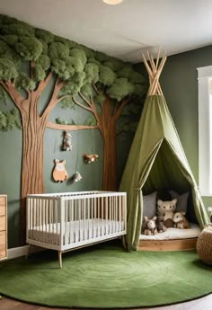 a baby's room decorated in green and white with a teepee tent for the crib