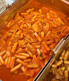 two pans filled with food sitting next to each other