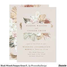 an elegant wedding card with flowers and feathers on the front, in neutral tones is shown