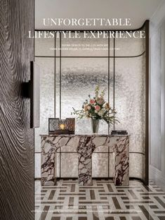 the front cover of an interior magazine with marble furniture and flowers in vases on top