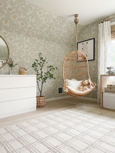 a living room with a swing chair and rug