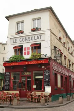 the outside of a restaurant with tables and chairs