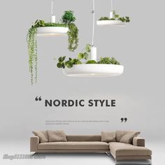 a living room with plants hanging from the ceiling and an advertisement for nordic style on the wall