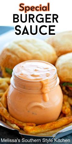 a plate topped with french fries and a jar of sauce