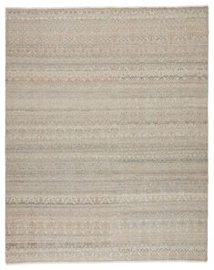 a beige rug with horizontal stripes on the top and bottom, in different shades of grey