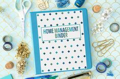 a binder with the words home management binder surrounded by craft supplies and scissors