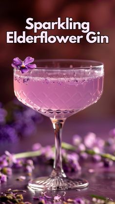 a glass filled with pink liquid next to purple flowers and the words sparkling elderflower gin