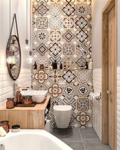 a bathroom with a sink, toilet and bathtub in the middle of it's tiled wall