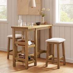 a wooden table with two stools next to it