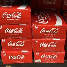 many boxes of coca - cola are stacked on top of each other