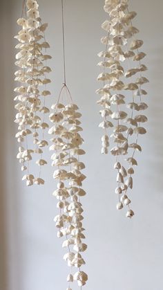 three white flowers hanging from the ceiling