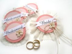 wedding garters with two gold rings on them and the name bridesmaid