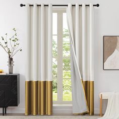 a living room with white and gold curtains