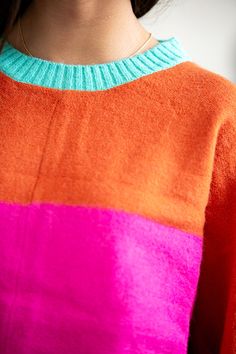 The Lucy Color Block Sweater showcases a vibrant color block design in bright pink, orange, and turquoise, adding a splash of bold color to your wardrobe. With its long sleeves and loose fit, it combines comfort with a playful, eye-catching style. Model is 5’4” wearing a size small Length of a small is 24.5" 52% Acrylic, 28% Polyamide, 20% Spandex Colour Block Jacket, Colorful Capsule Wardrobe, Kate Moss Street Style, Color Blocking Design, Outfit Options, Sweater Ideas, Multicolor Sweater, Color Block Jacket, Color Block Design