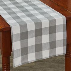 a wooden table with a checkered table cloth on it