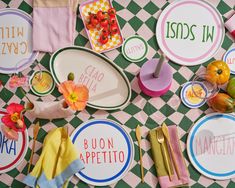 the table is covered with colorful plates and napkins