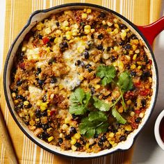 a skillet filled with mexican food and garnished with cilantro