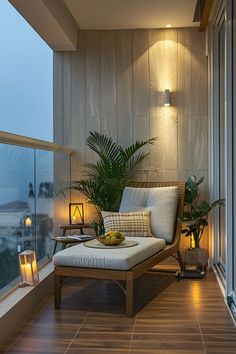 a balcony with a chaise lounge chair and potted plants on the floor next to it