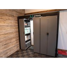 an open refrigerator in a room with wooden walls