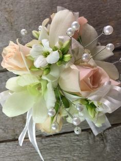 a bridal bouquet with flowers and pearls