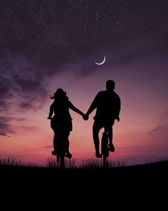 two people holding hands under the night sky with stars and moon in the back ground