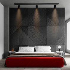 a modern bedroom with black and white wallpaper, red bedding and two lamps on the headboard