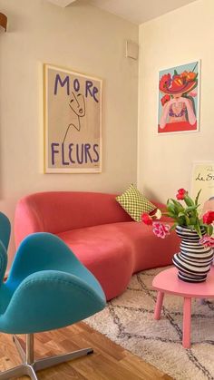 a living room filled with colorful furniture and pictures on the wall above it's windows