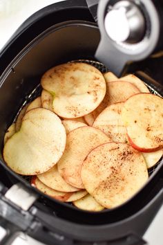 an air fryer filled with sliced apples